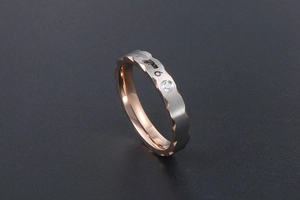Detail of rose gold and silver band with 'I will always' engraving and a small zircon
