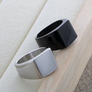 Macro shot of minimalist matte silver and black titanium steel signet rings for men
