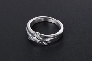 Detailed macro view of silver titanium steel ring with geometric star pattern engraving