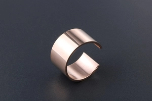 Macro detail of wide 18k rose gold plated titanium steel ring with polished finish
