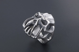 Detail of gothic monster skull ring with matte silver finish and punk cutout design