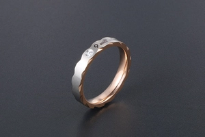 Detail of two-tone wave ring showing 'I will always' engraving and tiny zircon stone