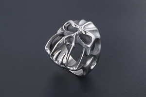 Macro view of retro punk monster skull ring showing detailed metal texture and carving