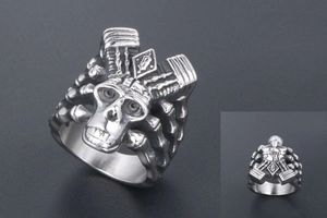 Macro view of punk style silver skull ring showing engine piston details and vintage steel finish
