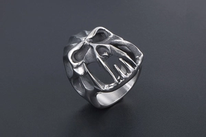 Macro shot of gothic monster titanium steel ring with carved skull and bone details