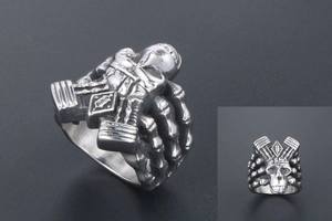 Detailed view of punk silver skull ring with crown motif and intricate skeletal texture