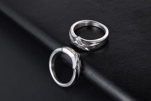 Macro shot of silver titanium steel rings featuring vintage embossed feather textures