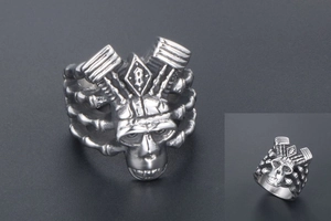 Macro shot of punk style titanium steel skull ring with engine piston and rib design