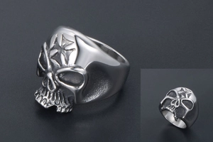 Macro view of punk skull ring with embossed star detail in polished stainless steel