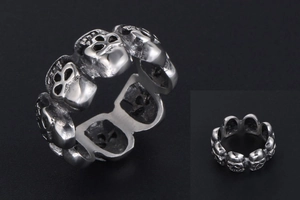 Macro view of vintage silver skull ring with gothic punk rock wrap-around design