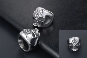 Close-up of silver skull ring with cross engraving and vintage industrial finish