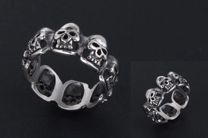 Detail of vintage skull eternity ring with oxidized finish and gothic carvings