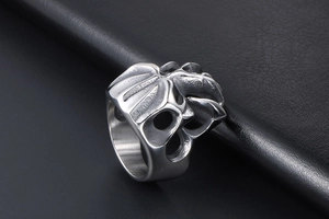 Detail shot of gothic monster skull ring with intricate silver-grey hollow metal texture