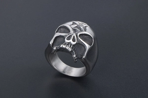 Detail of vintage punk skull ring with star engraving and antique silver finish