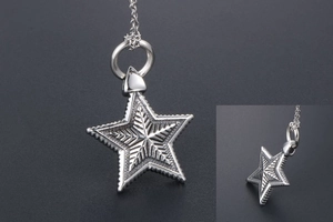 Macro shot of vintage star pendant with radial texture and aged silver metal finish