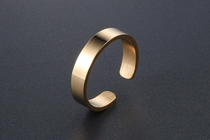 Close-up of golden 18k minimalist open ring featuring a delicate brushed matte finish