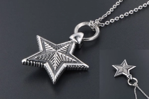 Macro detail of gothic star pendant with radial textures and industrial serrated edges