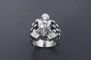 Macro view of punk men's skull ring with intricate helmet detailing and aged steel finish
