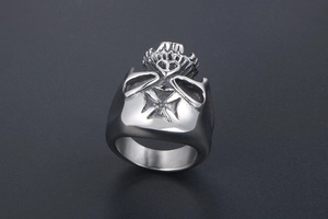 Macro view of heavy skull ring for men with iron cross relief on stainless steel