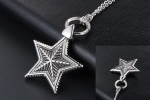 Macro detail of gothic star pendant with radial textures on vintage silver chain
