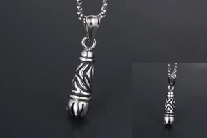 Close-up of gothic stainless steel pendant with engraved tribal patterns and vintage finish