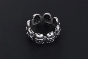 Detail view of vintage punk skull ring with oxidized silver finish and retro rock carvings