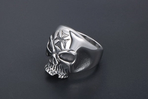 Detailed view of skull ring with star engraving on forehead in polished stainless steel