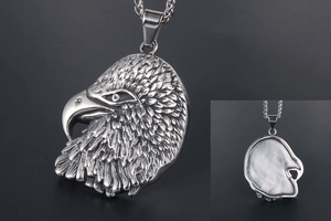 Detailed view of silver eagle head pendant showing intricate feather textures and hollow back