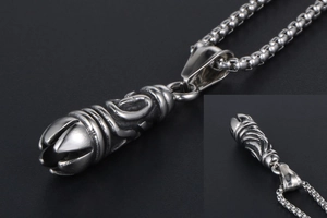 Close-up of gothic totem relief on a titanium steel pendant with a box chain necklace
