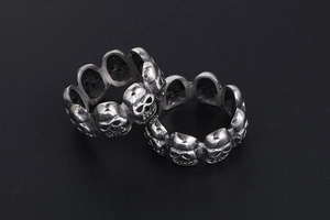 Detailed close-up of retro silver skull rings with punk gothic carved textures