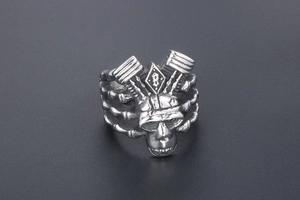 Macro view of men's punk skull ring with gothic lettering and vintage titanium finish