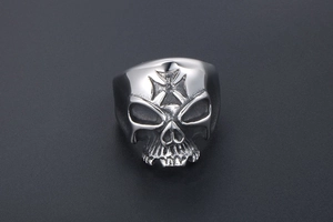 Detailed macro view of a men's skull ring with cross engraving in silver steel