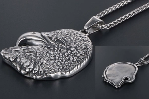 Macro view of eagle head pendant featuring detailed feathers and smooth silver metal back