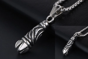Macro detail of gothic titanium steel cylinder pendant with spiral carved pattern