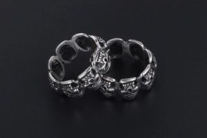Macro shot of silver gothic skull ring bands with vintage stainless steel finish details