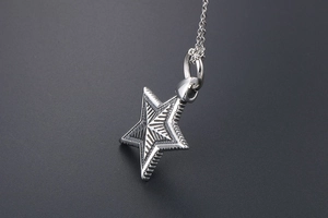 Macro shot of silver gothic star pendant necklace with radial lines and O-chain details