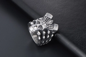 Detailed top view of punk skull ring with 3D embossed bone texture on leather background