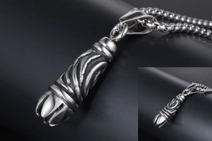 Detail view of gothic titanium steel pendant featuring complex spiral textures and box chain