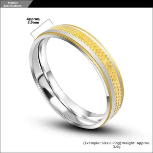 Detail of 3.9mm wide two-tone stainless steel ring with golden honeycomb texture