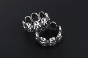 Macro shot of intricately carved gothic skull rings in vintage silver stainless steel