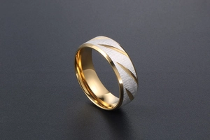 Detail of blue and gold men's titanium steel ring with diagonal grooves and brushed finish