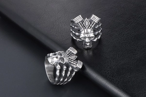 Detailed macro view of punk skull ring with mechanical elements and B letter engraving