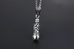 Macro view of gothic titanium steel pendant with embossed pattern and vintage oxidized finish