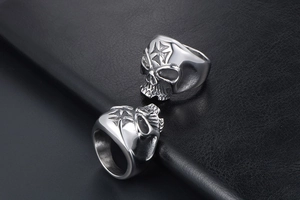 Macro detail of gothic skull ring with cross engraving on vintage stainless steel surface