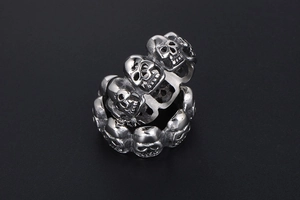Macro shot of gothic skull rings showing intricate metallic texture and punk design
