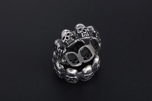 Detailed close-up of retro silver skull rings with punk rock 3D embossed skulls