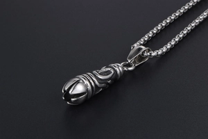 Macro detail of gothic titanium steel necklace pendant with intricate tribal carvings