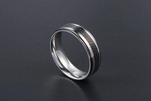 Macro shot of silver titanium ring with black hexagonal honeycomb textured inlay