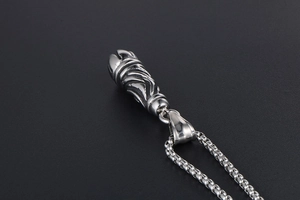 Detailed close-up of gothic titanium steel pendant with intricate spiral punk textures