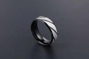 Macro detail of men's titanium ring featuring blue and gold stripes with brushed texture